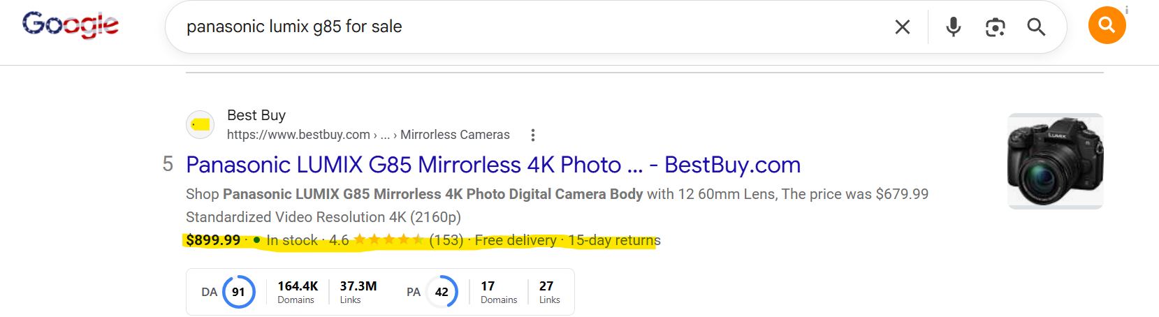 Screenshot of a Google organic search result for a camera. Highlighted text under the Best Buy listing shows the price, in-stock status, star rating, and delivery details, which are rich snippets generated by Product schema.